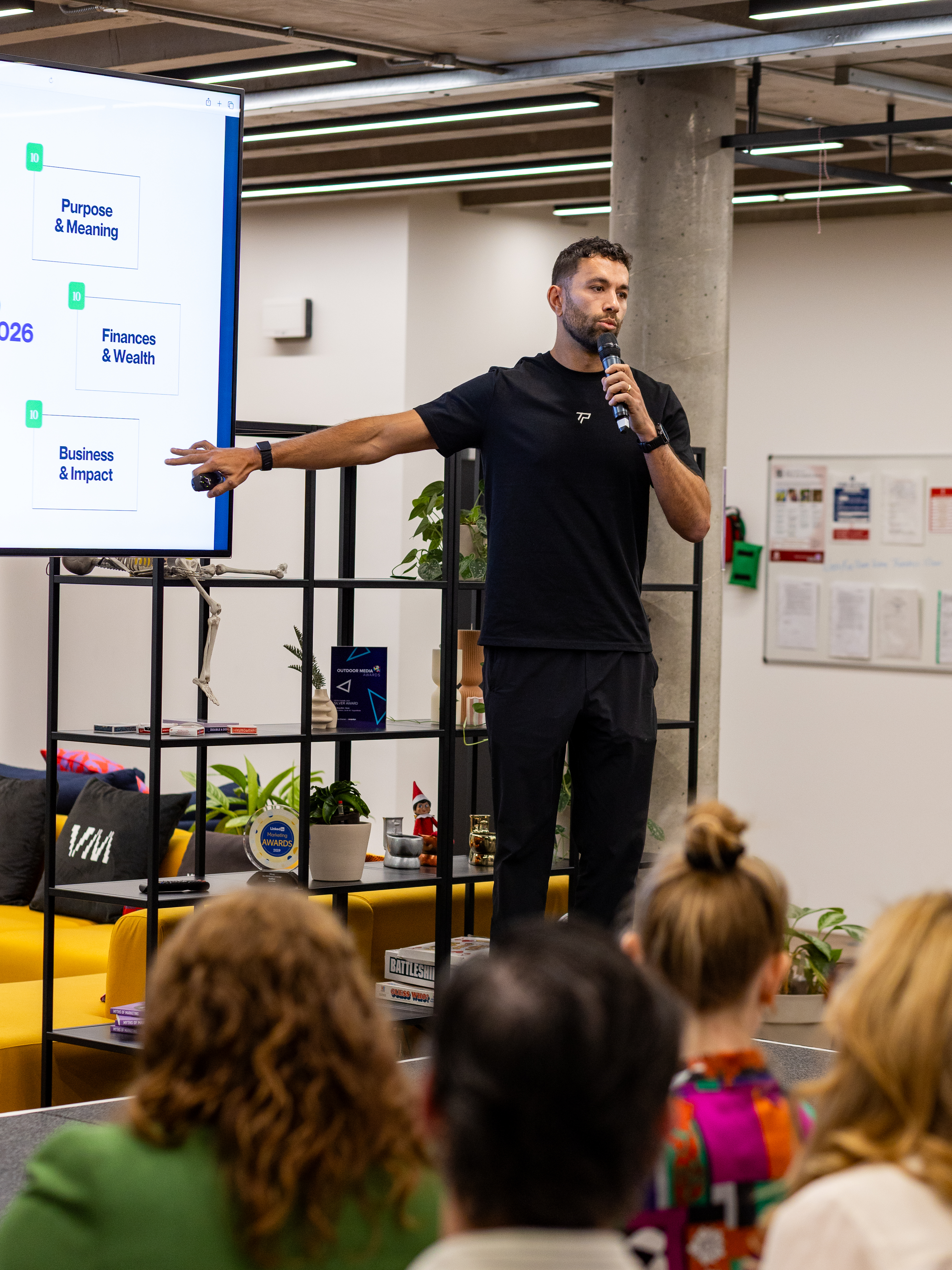 Alex presenting on stage